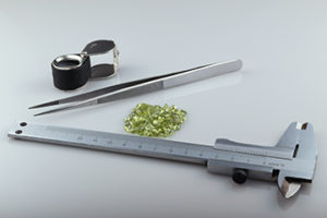 Natural peridot and tools gemologist